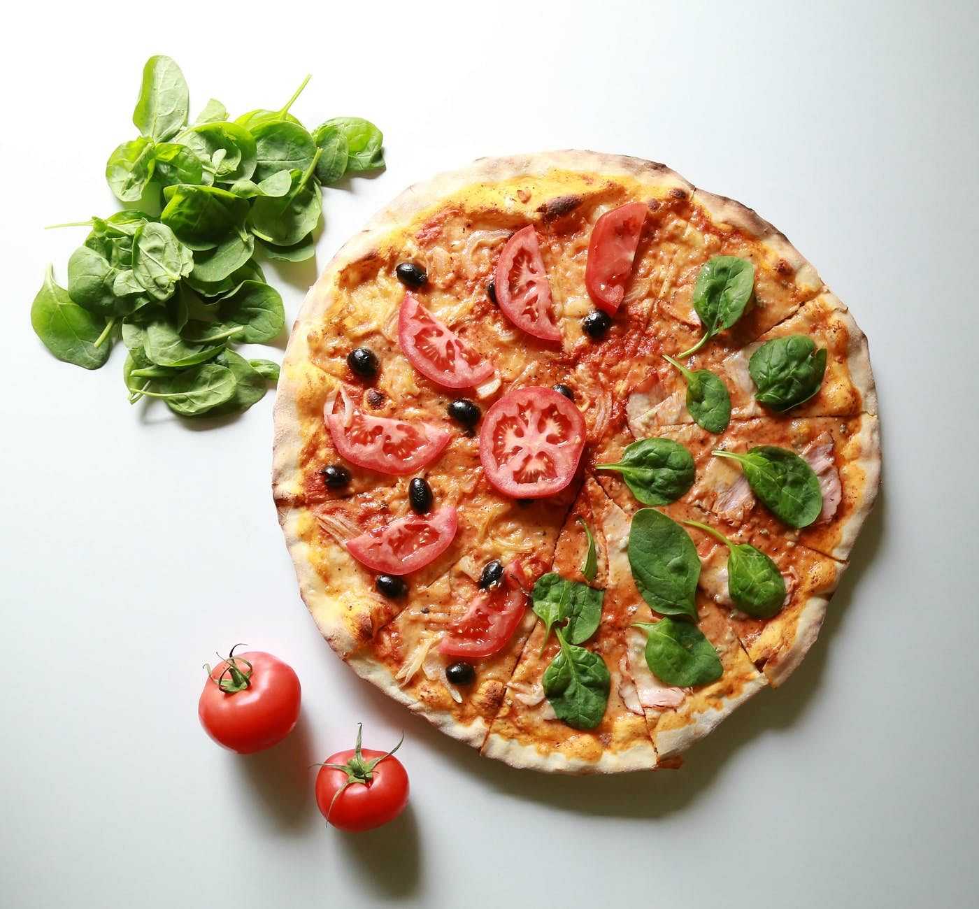 Overhead of a bazil and tomato pizza